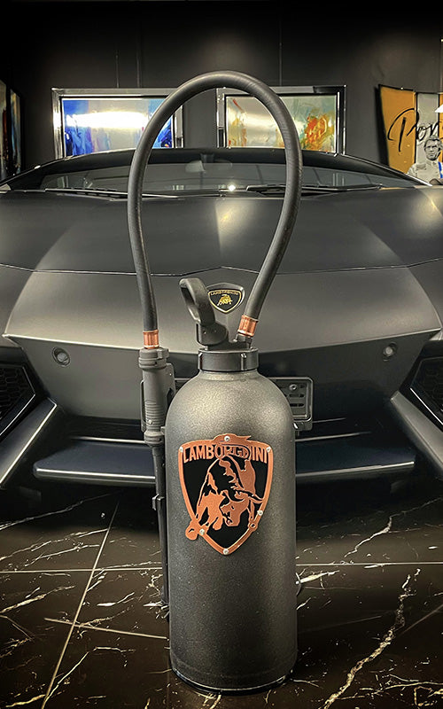 Extinguisher lamp black vintage Lamborghini with logo in front of a Lamborghini JLR Concept